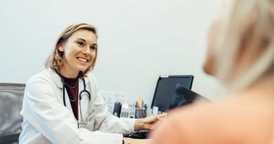 A female doctor talks with a patient.