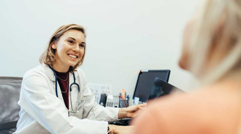 A female doctor talks with a patient.